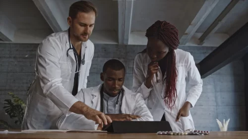 Three doctors looking at computer for an EHR Implementation