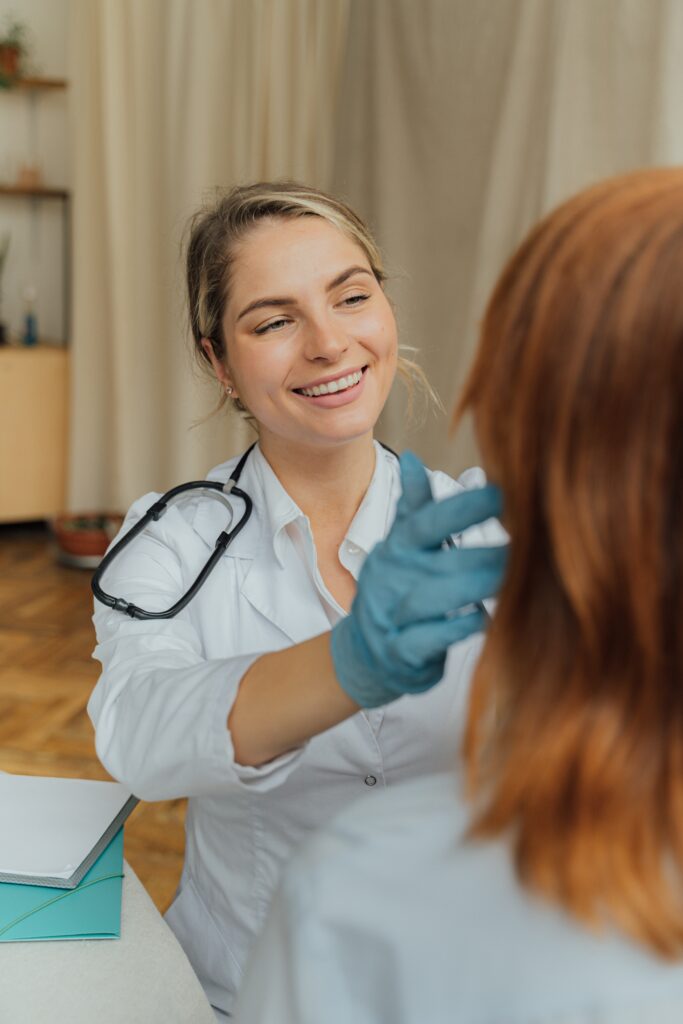 smiling woman doctor with gloves treats a patient