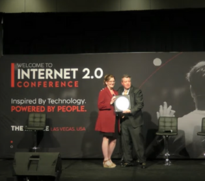 Emily Carlson receives an award at the Internet 2.0 Conference