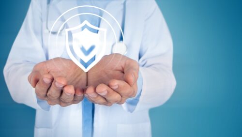 healthcare doctor holding cybersecurity shield