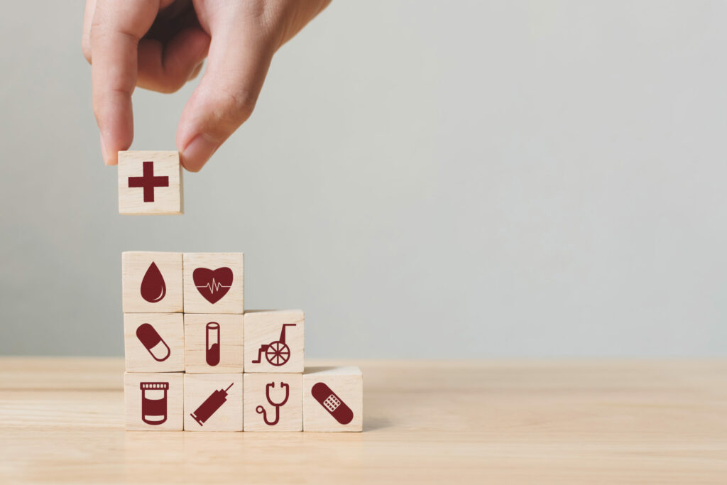 hand stacking medical themed blocks