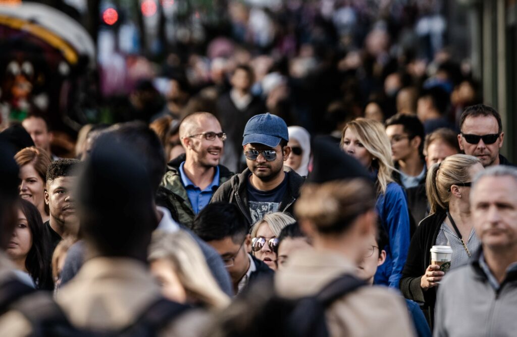 crowd of people walking down a street