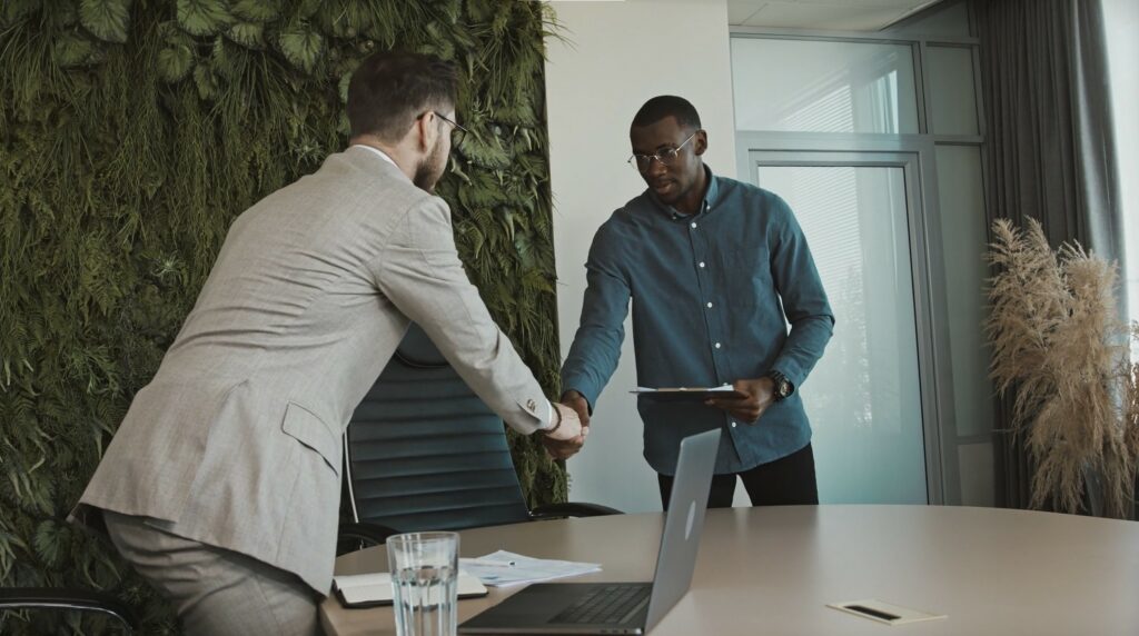 man walking into an interview and shaking hands