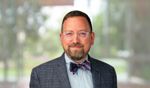 photo of jeff fuller wearing a bowtie with outdoors showing through a window