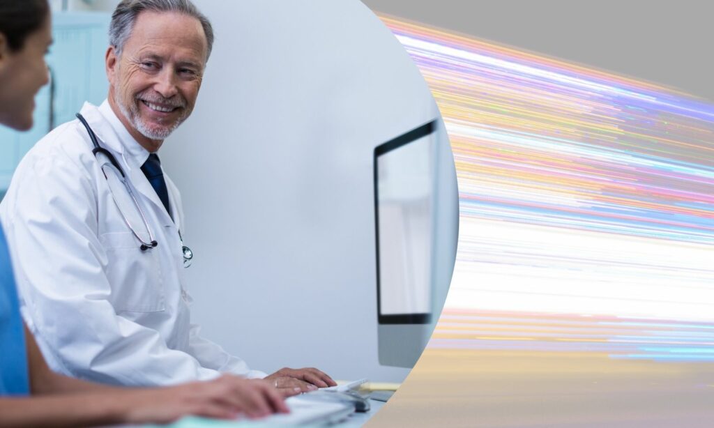 doctor at computer beside image of blurred lights