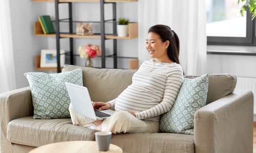 happy pregnant woman using digital solution for her healthcare