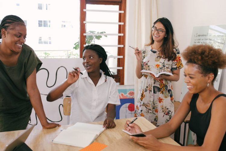 a group of women around a table discussing