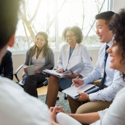 doctors stting in a circle discussing