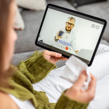 Virtual Care Consultation - Woman with tablet calling a virtual doctor