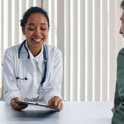 doctor consults with a patient in foreground