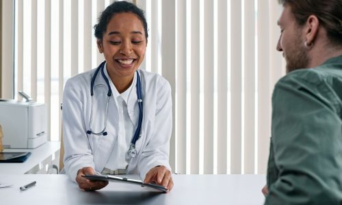 doctor consults with a patient in foreground