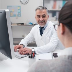 Doctor working with his computer