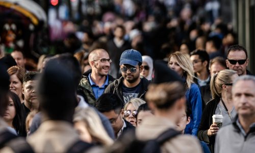 crowd of people walking down a street