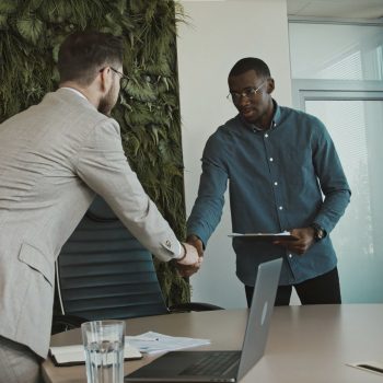 man walking into an interview and shaking hands