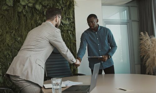 man walking into an interview and shaking hands