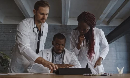 Three doctors looking at computer for an EHR Implementation